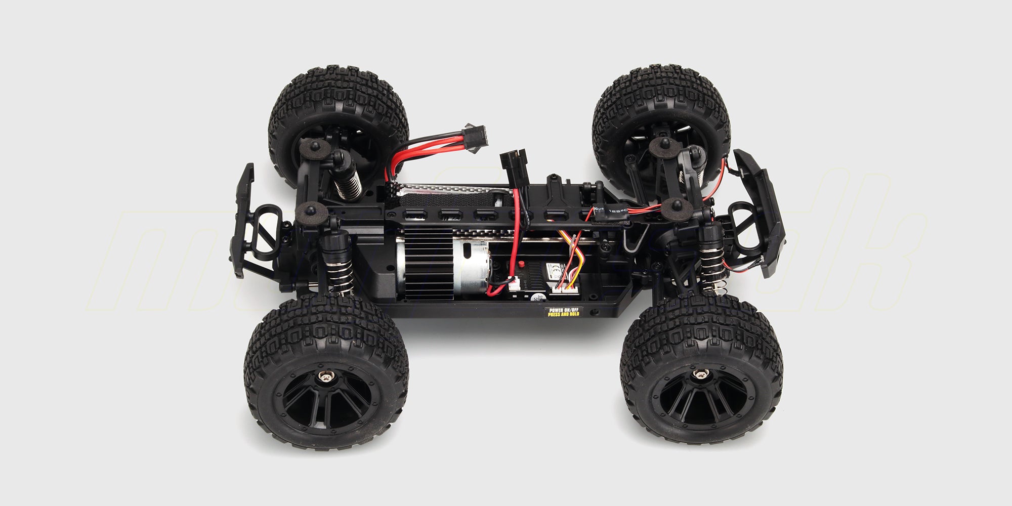 Chassis-detaljer af Hunter MT10 fjernstyret monster truck uden karrosseri vist på hvid baggrund.