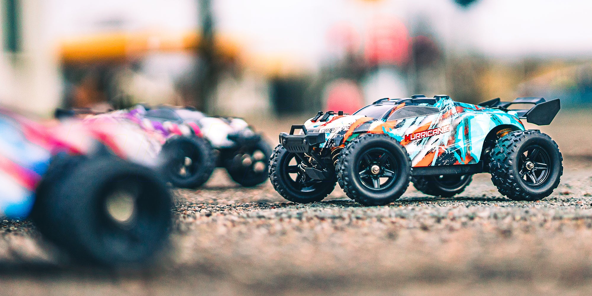 Grøn Hurricane fjernstyret bil kører hurtigt gennem støvet terræn i sollys.