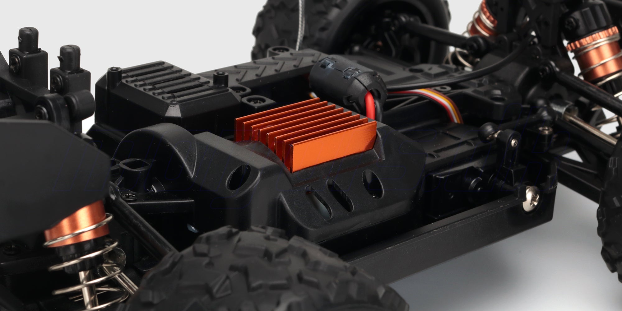 Nærbillede af de robuste dæk og det sorte karrosseri på en Hurricane fjernstyret bil.