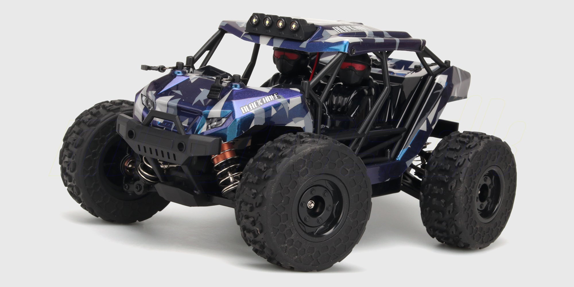 Hurricane fjernstyret monster truck med store dæk i aktion på udfordrende terræn.