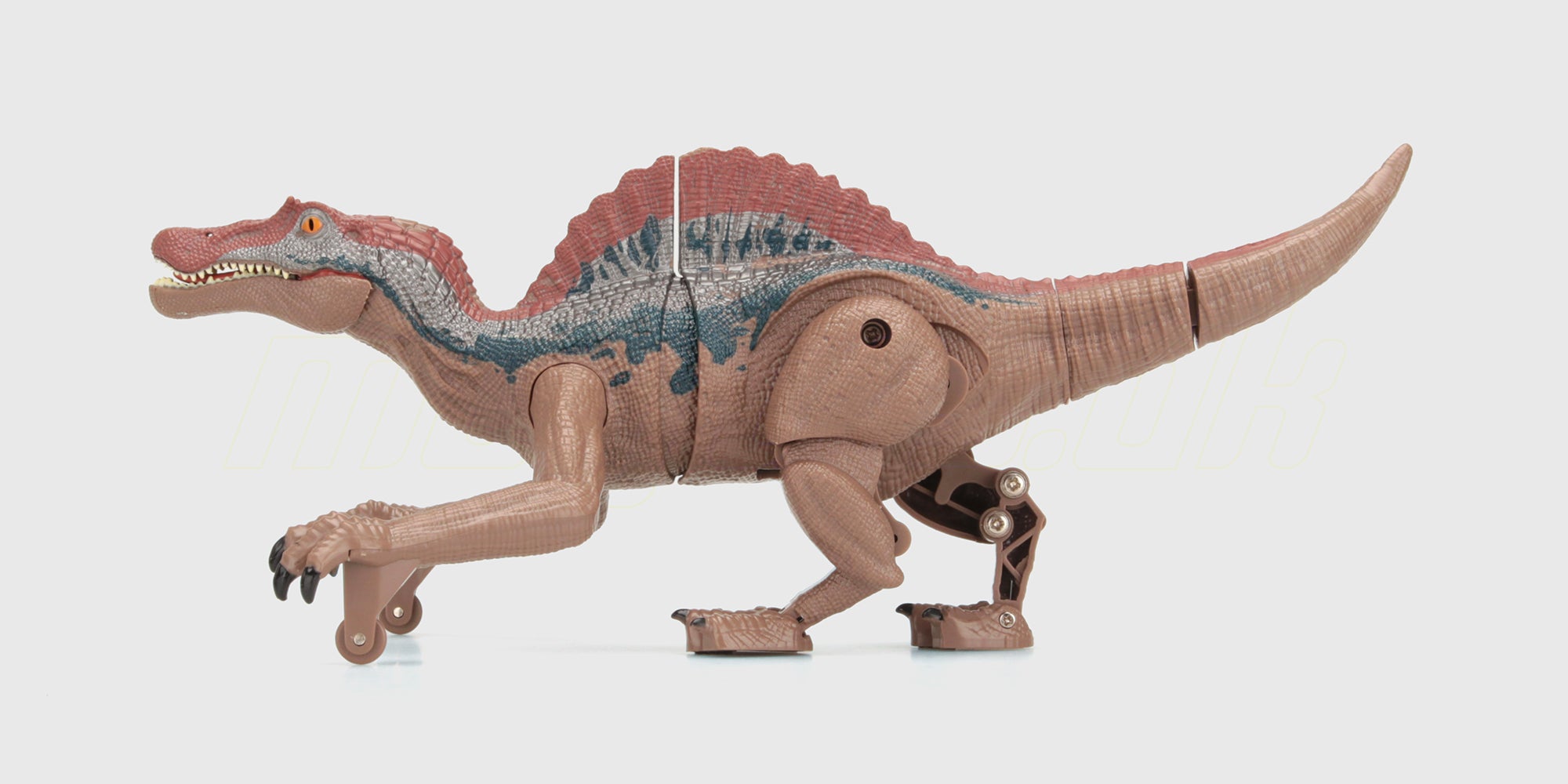 Brun og hvid lille dinosaur-figur i blødt materiale til leg og dekoration.