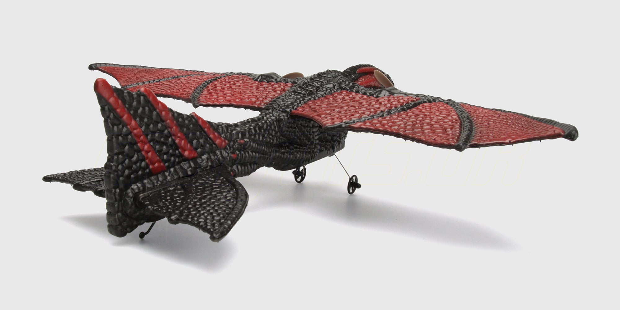 Grøn og orange Flying Animal drage legetøj med store vinger og detaljerede mønstre til børn.