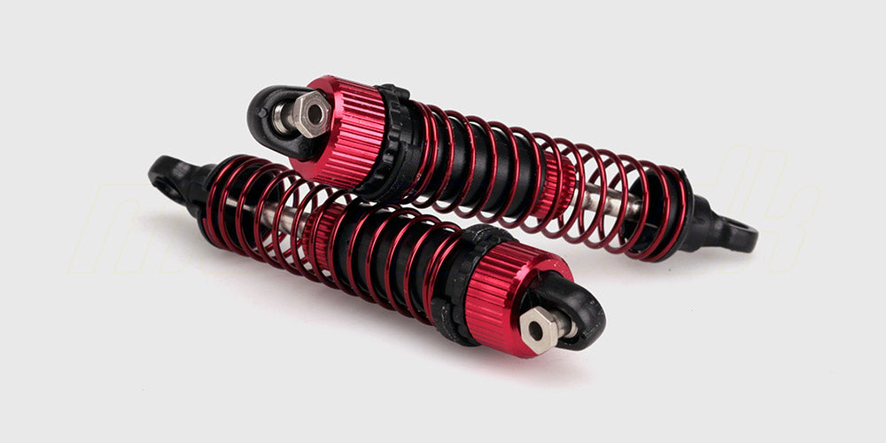 To sorte Spirit shock absorber støddæmpere med metalfjedre til en fjernstyret bil på hvid baggrund.