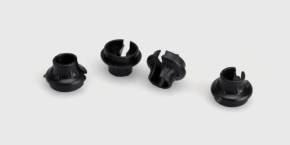 To sorte Spirit shock absorber cups i plast til montering på støddæmpere på en fjernstyret bil.