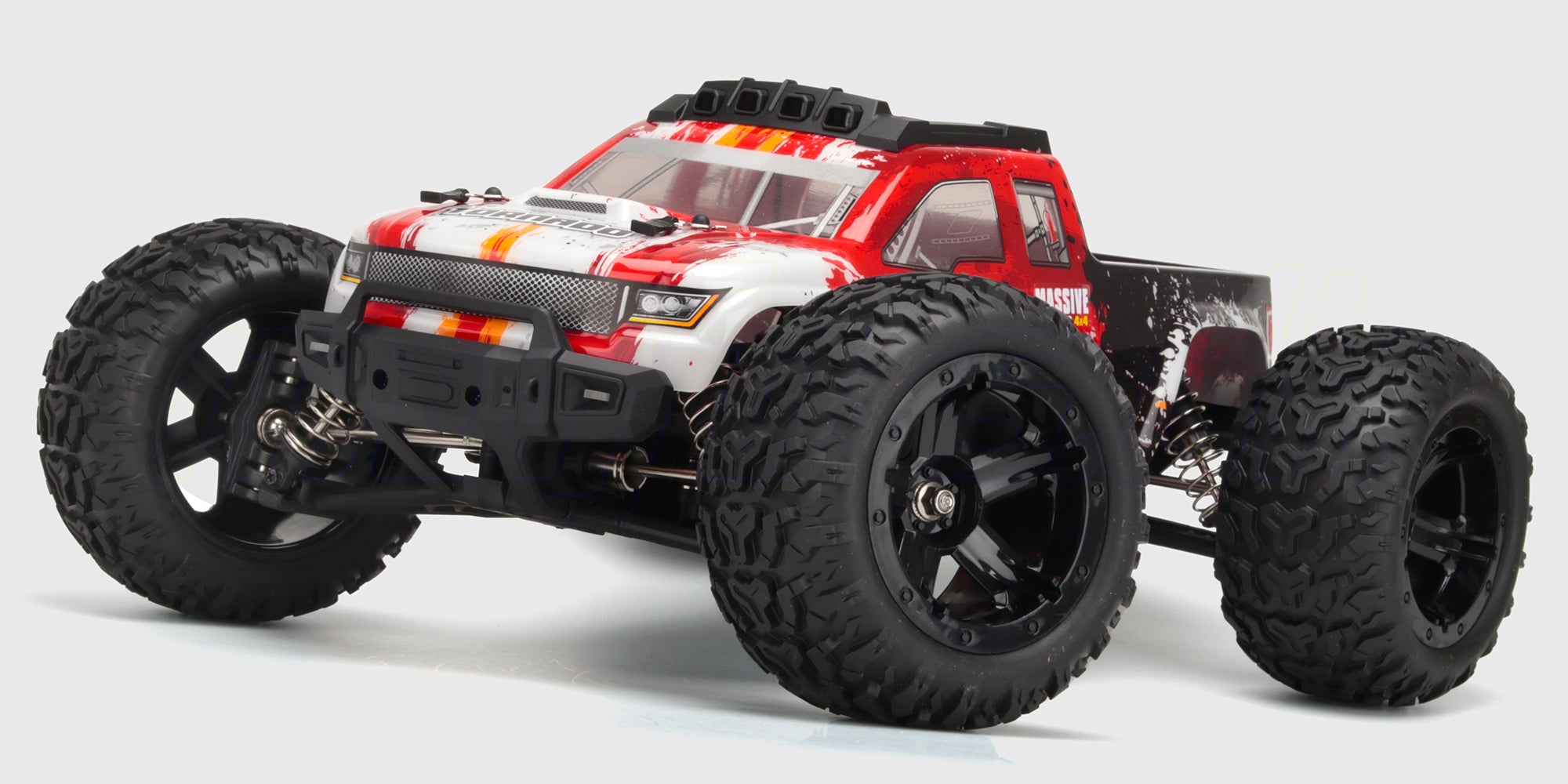 Grøn og sort HBX Tornado Brushless fjernstyret bil med store offroad-hjul i terræn.