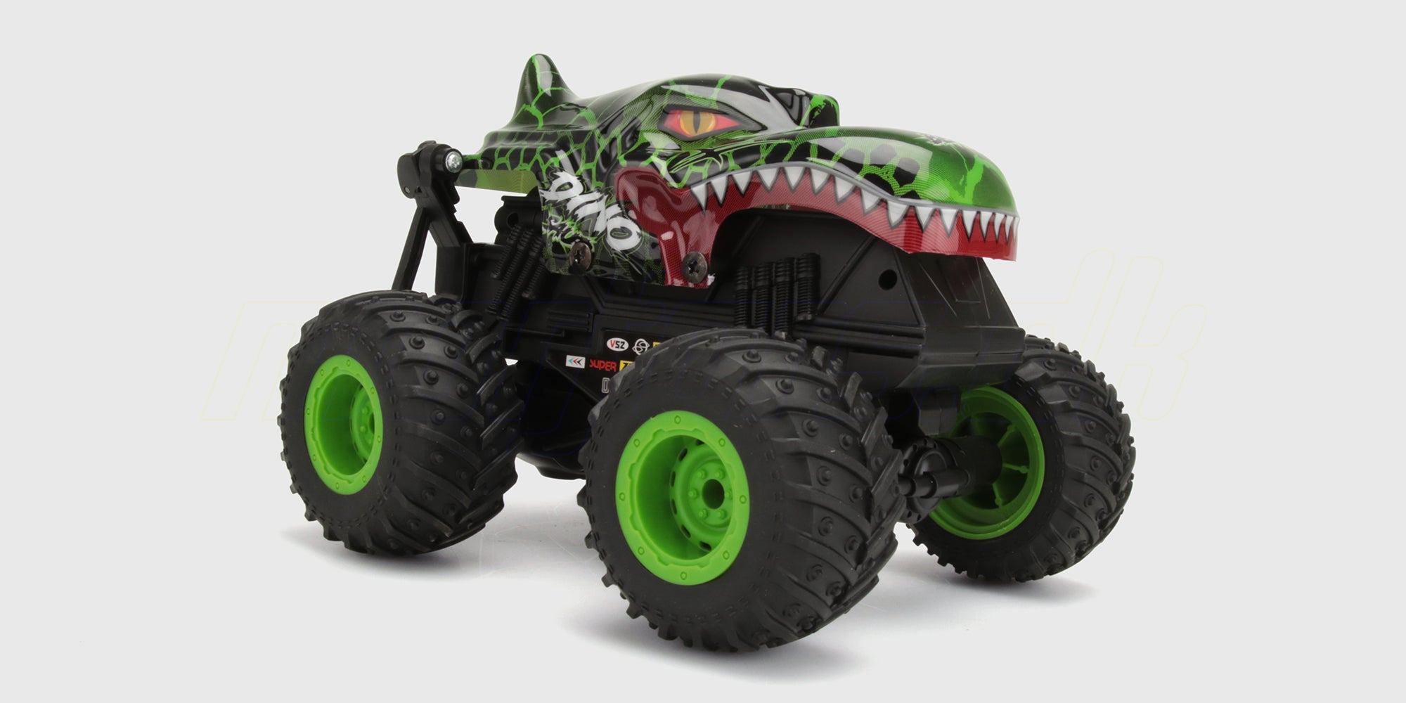 Orange Firedance Stunt Truck med store hjul i fuld fart på en vej.