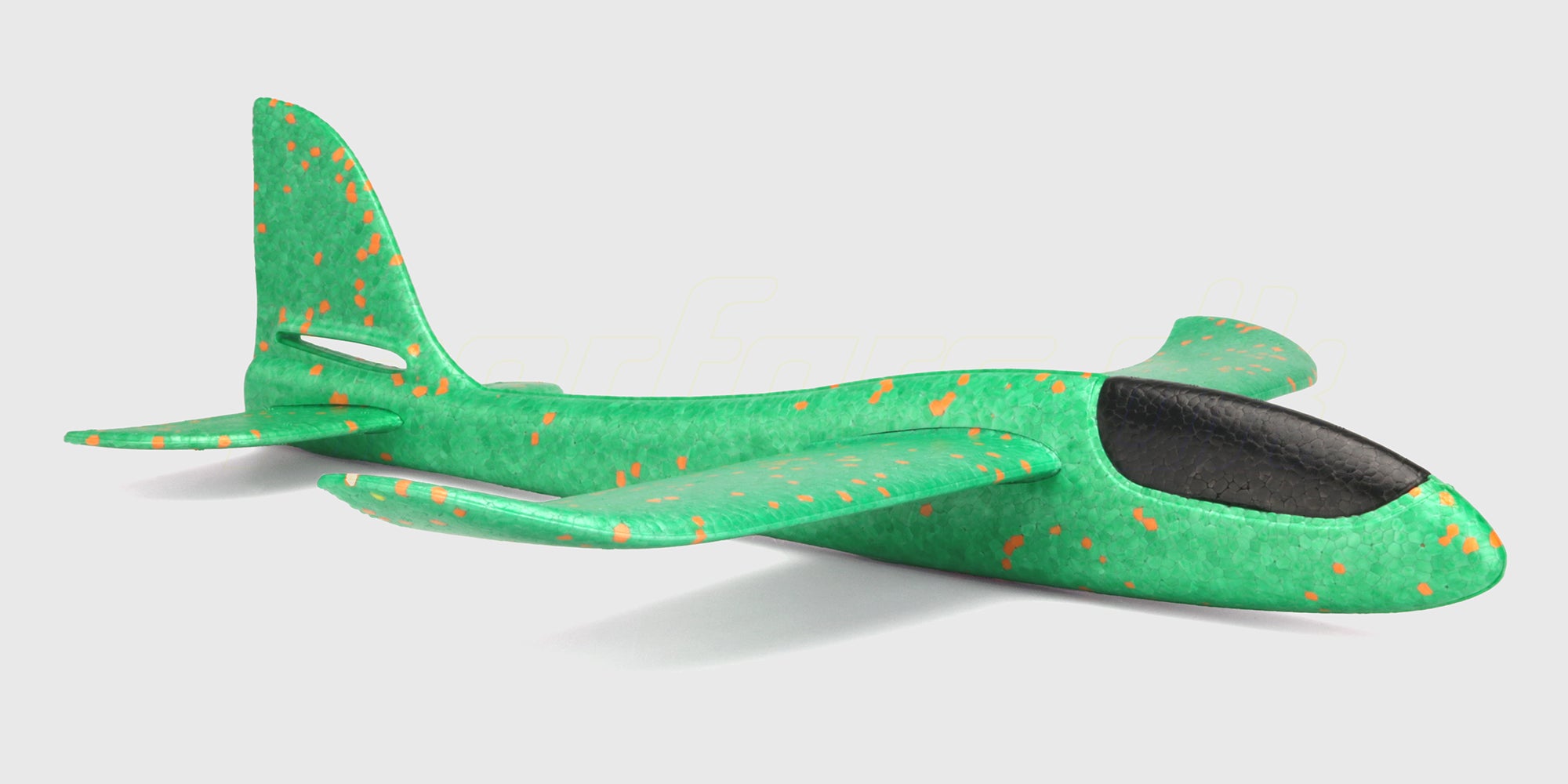 Grøn Super Glider skumflyver i robust EPP-skum klar til afflyvning mod en hvid baggrund.