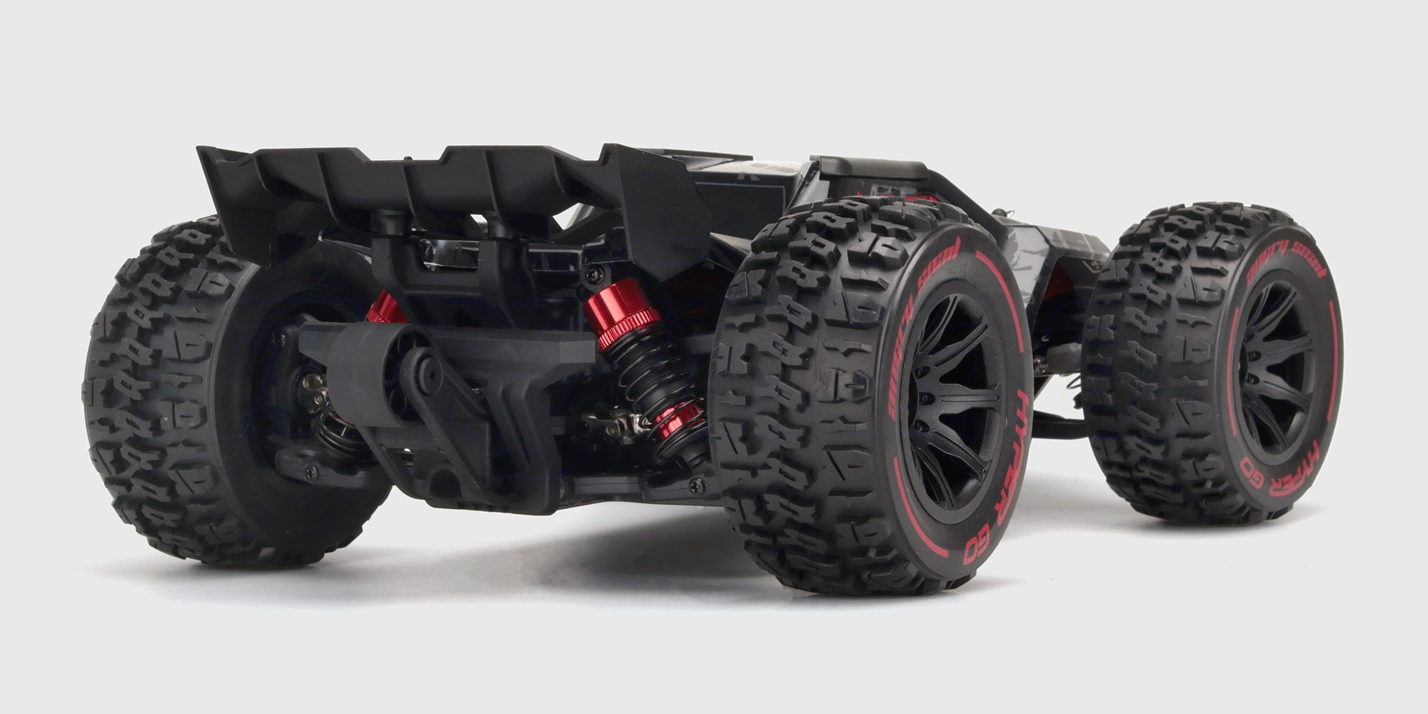 HyperGo EXtreme fjernstyret bil i hvid med sort grafik og robuste offroad-dæk set forfra på hvid baggrund.