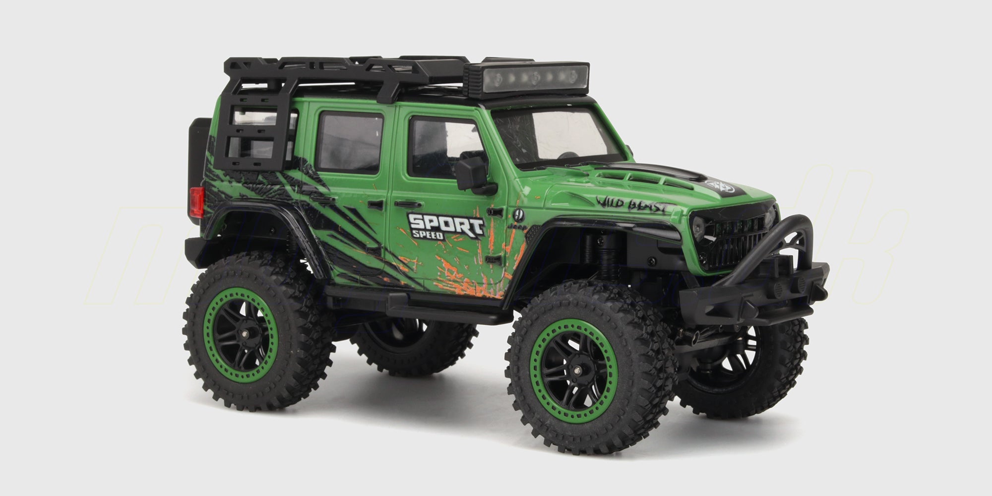 Grøn Wild Beast Mini Crawler fjernstyret bil med store offroad-hjul i terræn på grå sten.