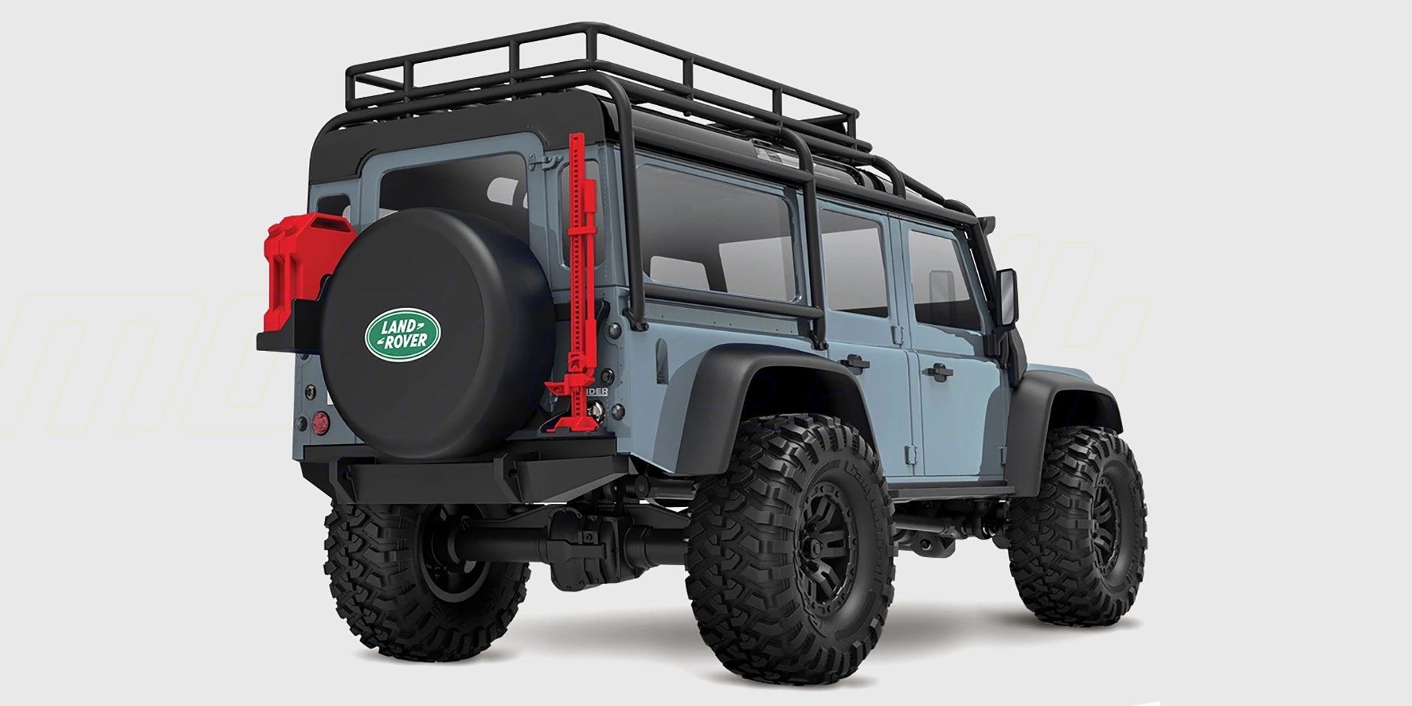 Blå Traxxas TRX-4M Defender crawler i skala 1:18 set fra siden på hvid baggrund.