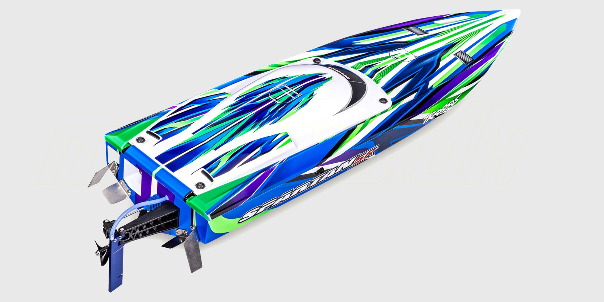 Traxxas Spartan SR brushless racerbåd i orange finish, der planer hurtigt hen over vandoverfladen.