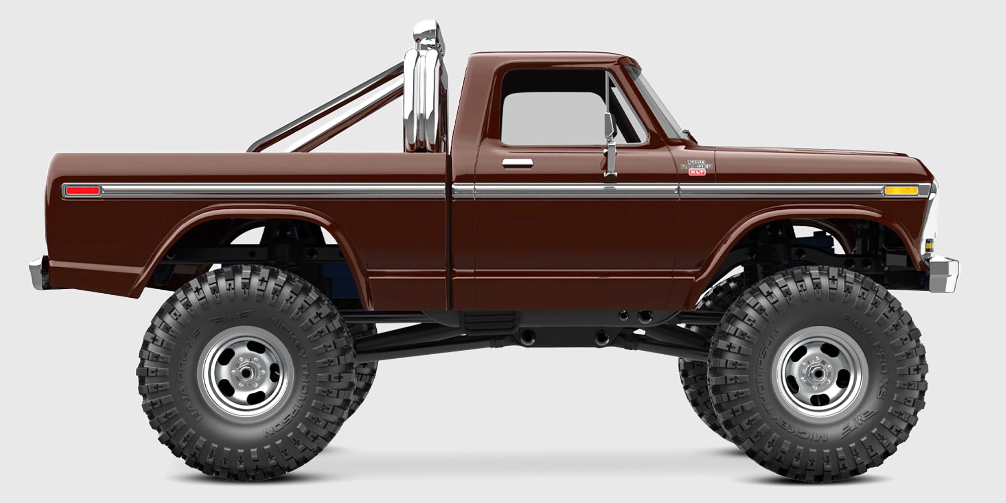 Sort Traxxas TRX-4M Ford F-150 High Trail Edition fjernstyret bil i terræn set fra siden.