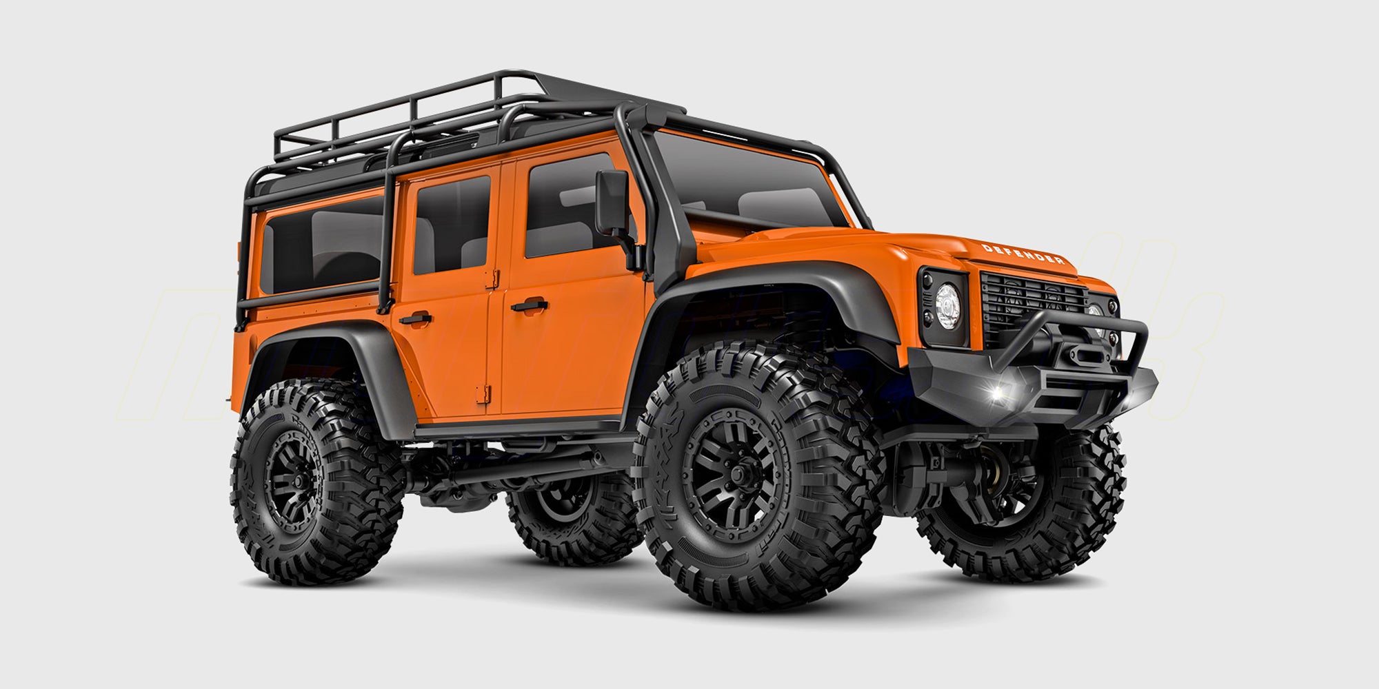 Orange Traxxas TRX-4M Defender crawler i 1:18 skala set fra siden på en hvid baggrund.