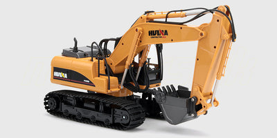 Gul fjernstyret gravemaskine med bevægelig skovl og sorte larvefødder til leg.